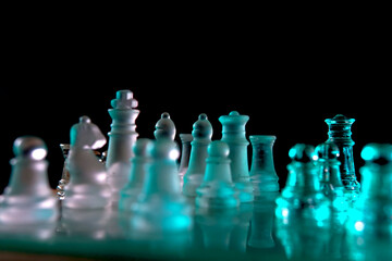 Colorful glass chess set illuminated by LED lights