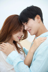 Young Asian Couple Embracing on Beach Shore in Summer