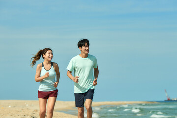 Young Couple Jogging on Sandy Beach