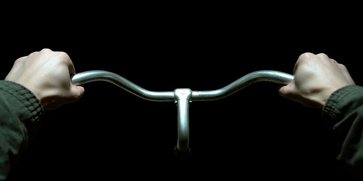 Hands Gripping Bicycle Handlebars - Powered by Adobe