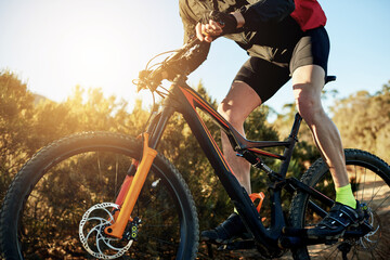 Bike, gears and legs with man in mountains for outdoor exercise, fitness or hobby. Flare, frame and trail riding with person cycling in nature for challenge, performance or sports training closeup