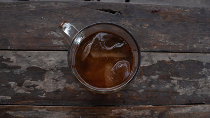 Sweet Iced Tea in Clear Glass on Wooden Table – Refreshing Beverage Photo