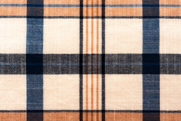 The texture of linen fabric in a large cage of blue, red, yellow and white. Scottish tailoring...