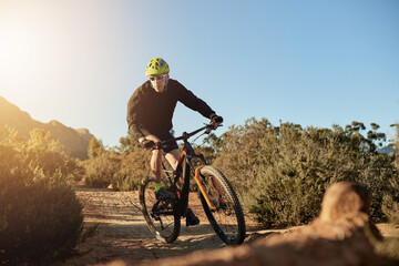 Obraz premium Mountain bike, journey and man with fitness, energy and environment with competition. Person, challenge and cyclist with practice, travel or countryside with adventure, wellness or nature with hobby