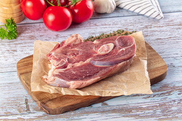 Raw lamb steak with bone