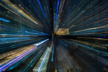 Bangkok, Thailand - April 28, 2025 : A nighttime view of a long exposure busy city street. LED illumination at night outside the buildings.