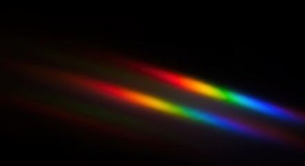 Obraz premium Faint rainbow beams shimmer gently in blackness, evoking mystery, light, and spectral elegance