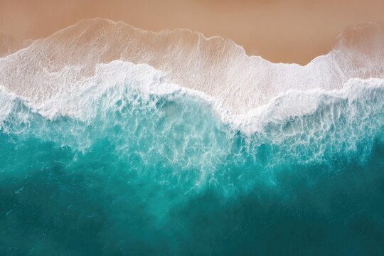 drone captures coastal beauty from high top-down view revealing sandy shoreline meeting ocean waves from above
