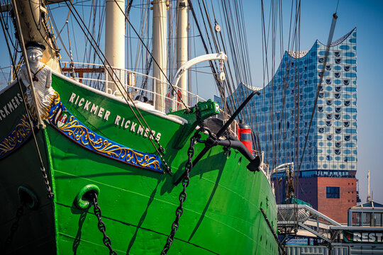 Scenic front view of the historic sailing ship Rickmer Rickmers, moored at the pier in front of the Elbphilharmonie concert hall in Hamburg, Germany