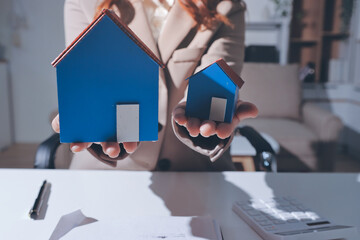 Female Real Estate Broker presenting and advised to .model home and building project detail in the...
