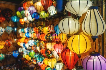 Traditional Asian lanterns glow with warm light creating festive magic and cultural charm, Colorful handmade lights illuminate space radiating beauty and heritage © goami