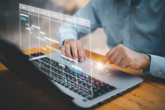 Scheduling activities with a planning software, Corporate strategy for finance, operations, sales, marketing. Project manager working with Gantt chart schedule to plan tasks and deliverables. - Powered by Adobe
