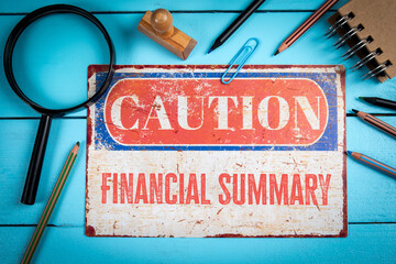 Financial Summary Concept with Vintage Caution Sign and Office Supplies