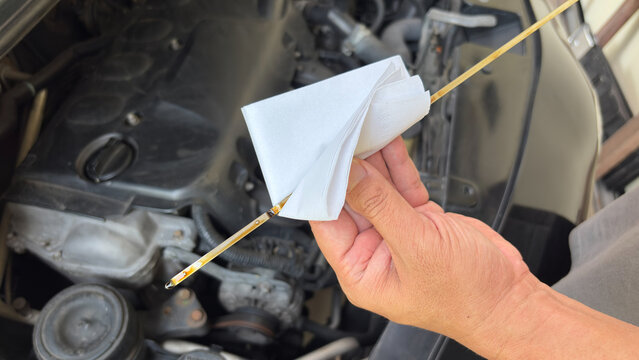 Mechanic man hand checking engine oil refill car maintenance close up engine transport industry. Services car engine machine concept,