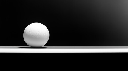 White sphere on a minimalist surface against a dark background.
