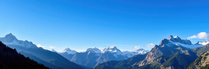 Naklejka premium Majestic Alpine Panorama: Snow-Capped Peaks and Serene Blue Sky