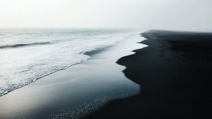 Misty black sand beach, ocean waves, aerial view, serene coastal landscape, travel photo
