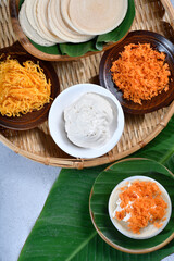 Vertical top view of Thai crispy pancakes topped with strips of egg yolks setup scenc