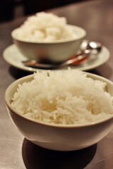 Two bowls of fluffy white rice, ready for a tasty meal, photographed up close and centered.