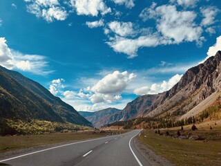 Scenic autumn landscape in altai mountains with open highway and dramatic sky for travel and...