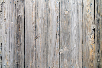 Old weathered gray wood surface with irregularities and signs of aging.