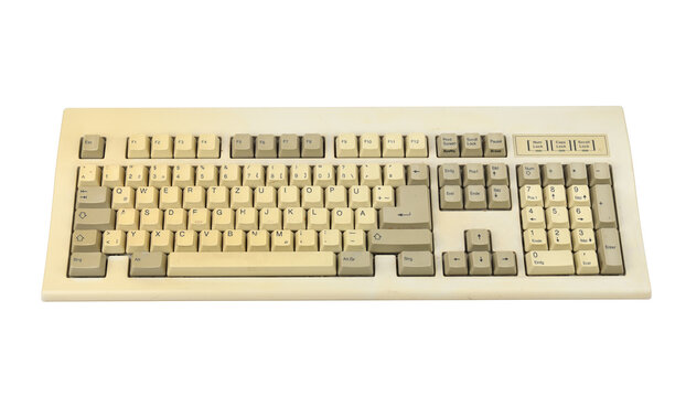 Vintage computer keyboard from the 1990s isolated on white background.