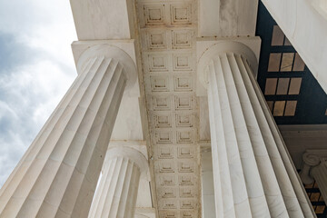 Fototapeta premium Building with elegant white columns. View from below.