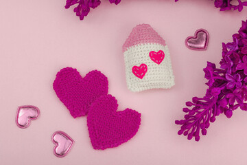 Handmade Valentines Day concept. Creative house figurines, traditional hearts, spring crocheting