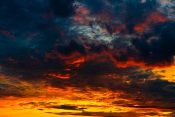 Orange, red and black clouds in the sunset sky