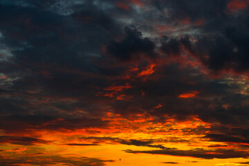 Orange, red and black clouds in the sunset sky