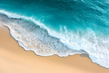 A stunning aerial view of a serene ocean wave gently lapping against a sandy beach, showcasing vibrant turquoise waters and soft golden sand.