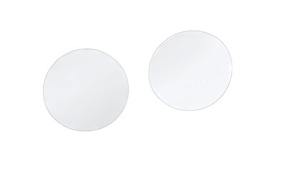 Two circular blank mirrors reflecting light. positioned side by side on a clean surface. ideal for interior design and home decor applications. with a soft-focus background suggesting tranquility