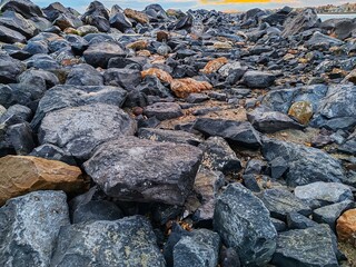 Detail of the imposing rocks for the artificial reef deposited to prevent coastal erosion of the Ostia seafront.