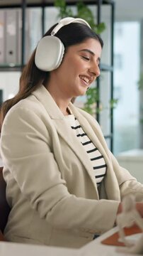 Headphones, music and business woman in office for dance, streaming song and typing creative article. Radio, technology and happy worker listen to favorite sound, album or audio critic writing review