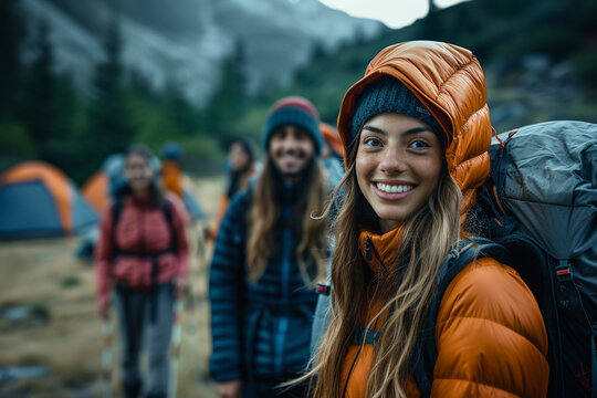 A diverse group of friends, both men and women, embark on an exhilarating hiking and camping adventure in breathtaking mountains, reveling in joys of outdoor life and creating unforgettable memories t