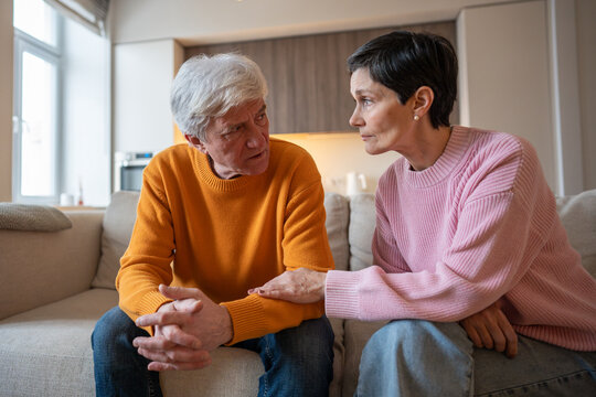Compassionate wife provide silent support holding hands with overwhelmed husband, senior couple challenge. Relationship struggles, emotional marital comfort, non verbal communication, vulnerability