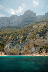 Tourists enjoying stunning cala luna beach in sardinia, italy