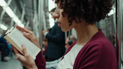 Passengers reading on a moving subway train - Powered by Adobe