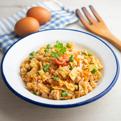 Three-delight Asian rice with vegetables, egg, and green beans.