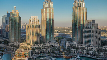 Obraz premium Dubai Marina skyscrapers aerial timelapse, port with luxury yachts and marina promenade