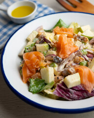 Waldorf salad with delicious smoked salmon, apple, raisins, walnuts, and mayonnaise dressing.