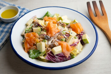 Waldorf salad with delicious smoked salmon, apple, raisins, walnuts, and mayonnaise dressing.