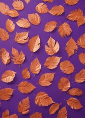 Obraz premium Dry orange metallic leaves patterned on violet backdrop , stock photo, dry