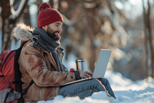 A dedicated freelancer embraces winter season as he diligently works outdoors with his laptop and thermos, finding inspiration and motivation in crisp air and serene surroundings    
