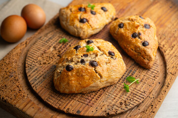 Triangular English scones with dark chocolate chips.