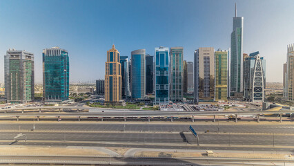 Aerial view of Jumeirah lakes towers skyscrapers all day timelapse with traffic on sheikh zayed road.