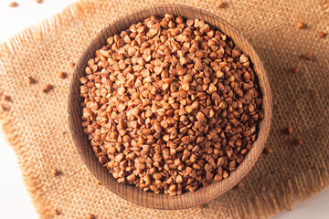 Buckwheat groats on wooden background. Healthy cereal concept.  