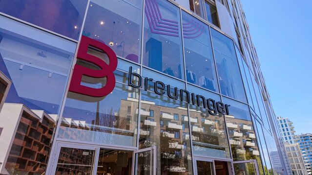 HAMBURG, GERMANY - APRIL 29, 2025 - Modern architecture of Breuninger department store reflecting surrounding buildings in Hamburg Hafencity, Germany