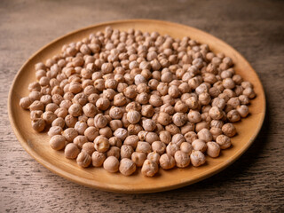Raw Chickpeas on a rustic wooden table. Dry chickpea background close up. Chickpea legumes seed background.