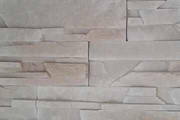 Modern decorative finish with textured tiles imitating natural stone. Light beige tones and geometric layout create an elegant backdrop for minimalist, loft, or eco-style interiors.